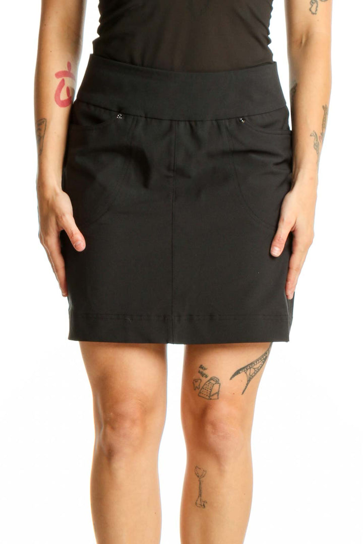 Hard Tail black mini skirt with elastic waistband and snap details, front view on model