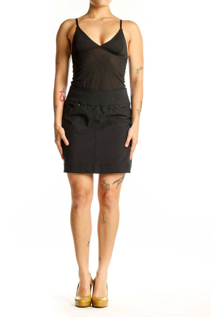Hard Tail black mini skirt with elastic waistband and snap details, front view on model