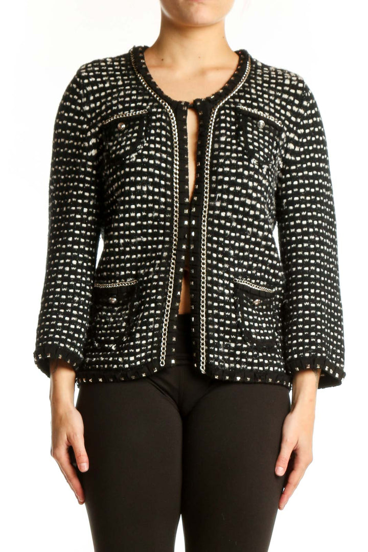 Black studded cropped jacket with all-over metallic studs, front view on model