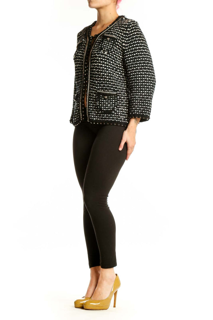 Black studded cropped jacket with all-over metallic studs, front view on model