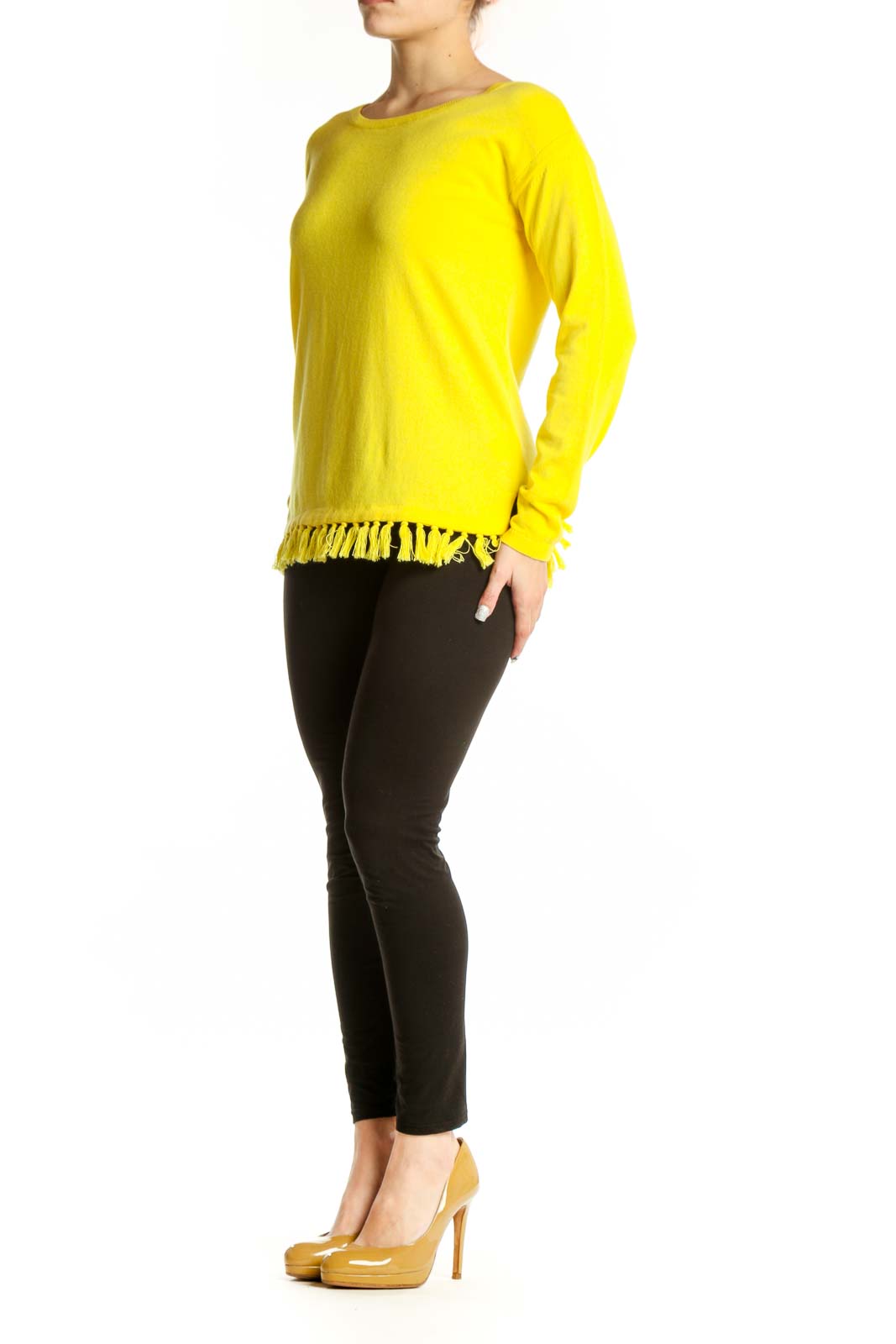 Yellow cashmere blend sweater with fringe trim worn with black pants, front view