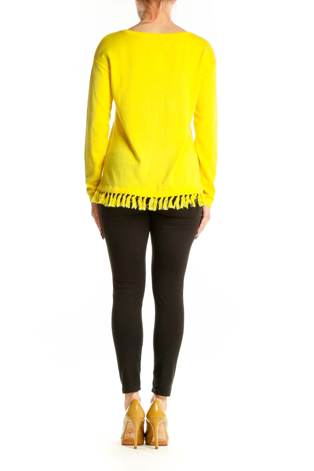 Yellow cashmere blend sweater with fringe trim worn with black pants, back view