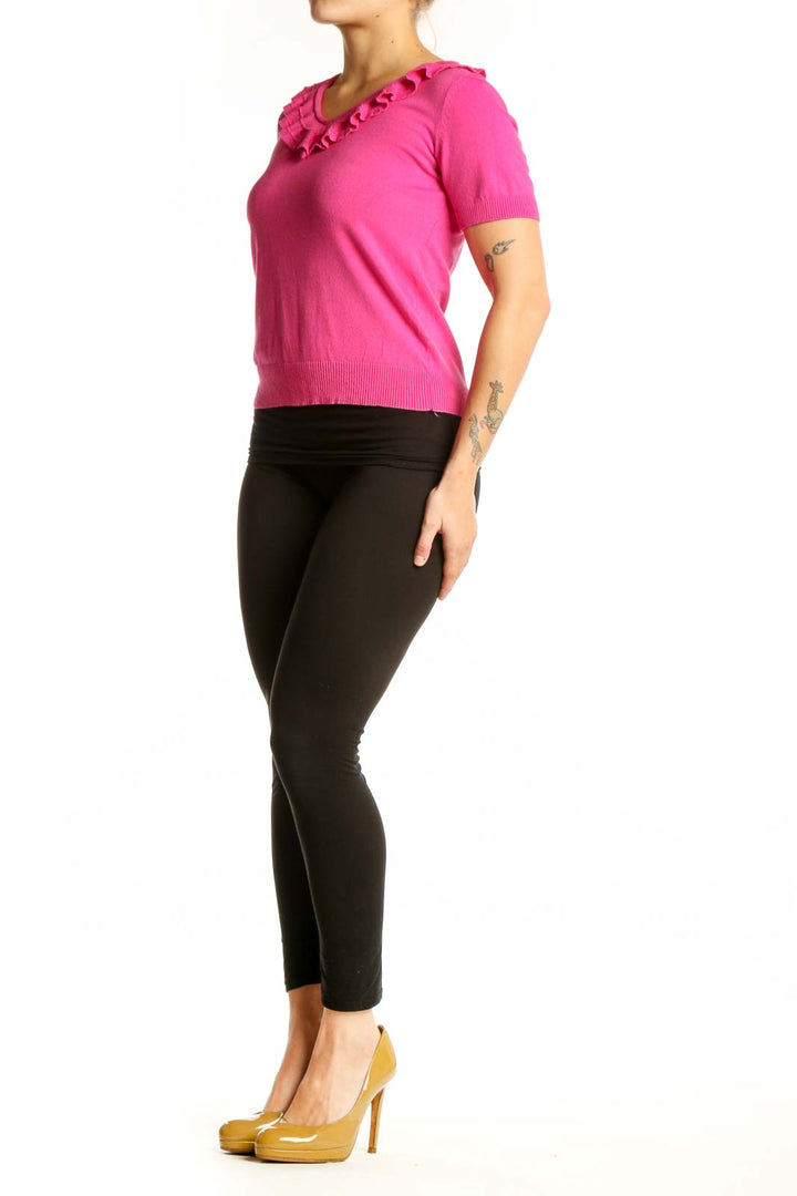 Pink ruffle V-neck short sleeve top with ruffled neckline detail, front view