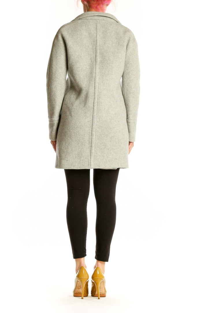 Back view of cream wool hooded coat showing full-length zip closure and relaxed silhouette