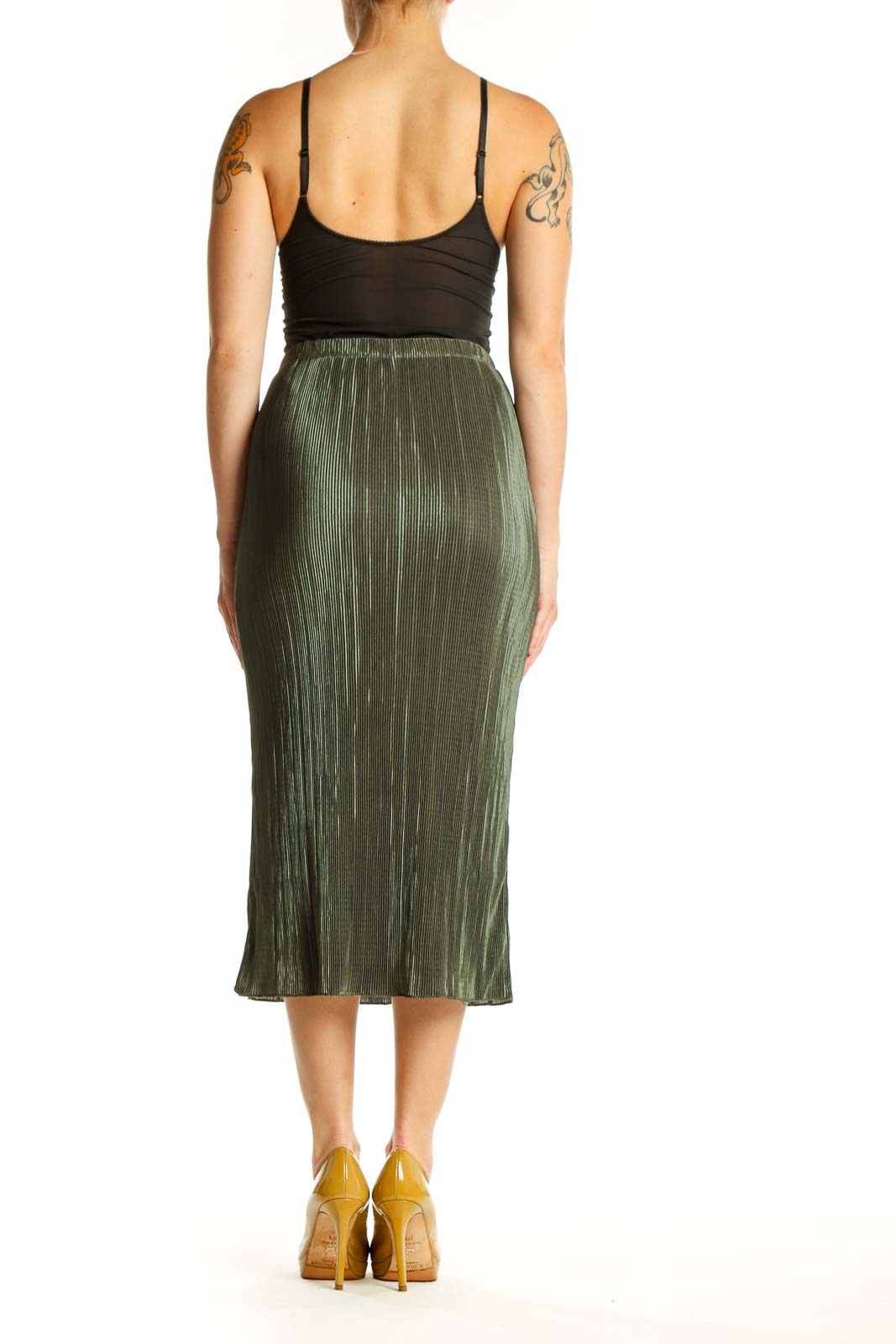 Back view of green pleated midi skirt showing the elegant drape and length of the pleated design