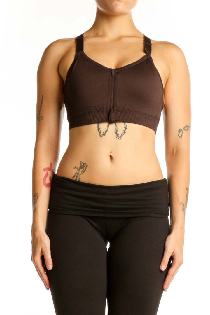 Black sports bra with front zip closure and adjustable straps, front view on model