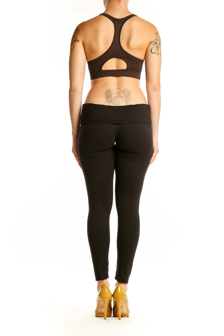 Black sports bra with front zip closure, back view showing strap design and fit