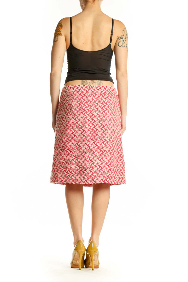 Pink geometric A-line skirt by Talbots with coral and cream lattice pattern, back view on model