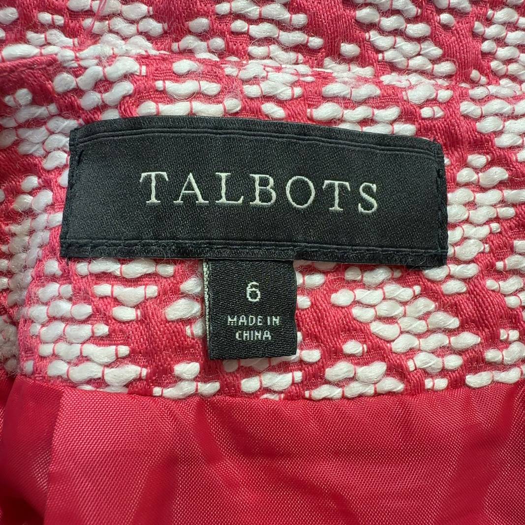 Pink geometric A-line skirt by Talbots with coral and cream lattice pattern, back view on model