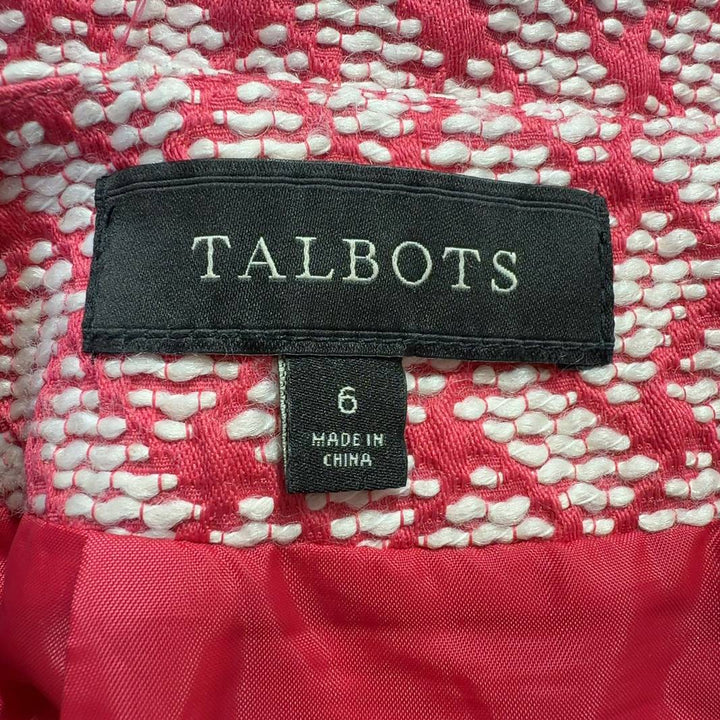 Pink geometric A-line skirt by Talbots with coral and cream lattice pattern, back view on model