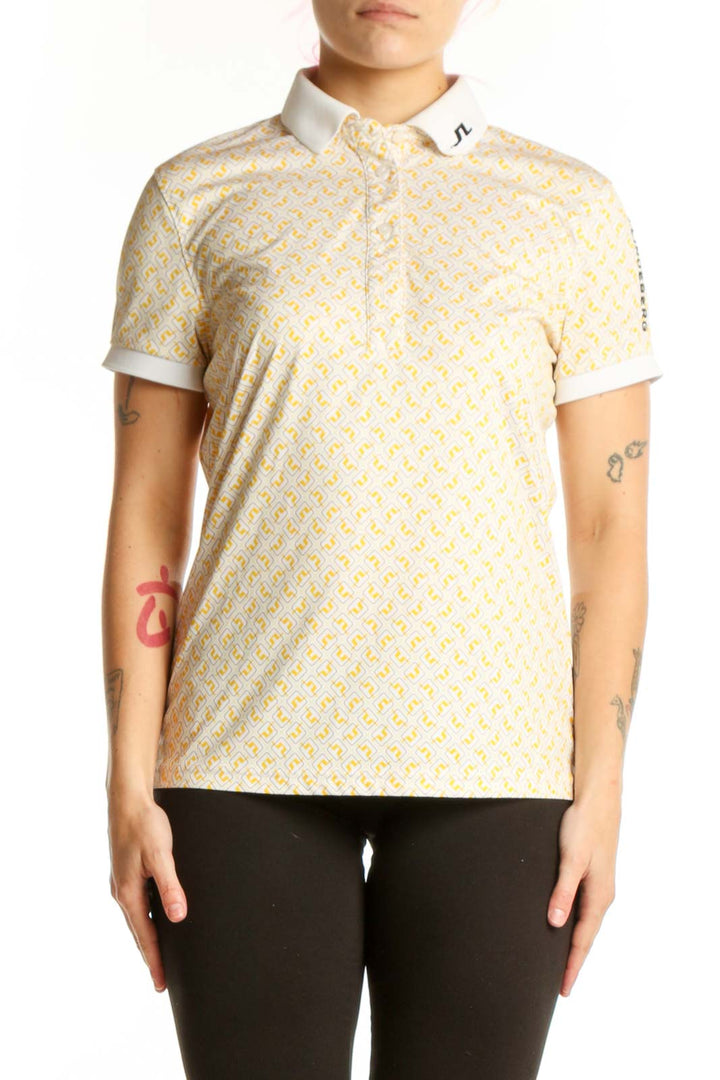 J. Lindeberg yellow geometric print polo shirt with white collar trim, front view on model