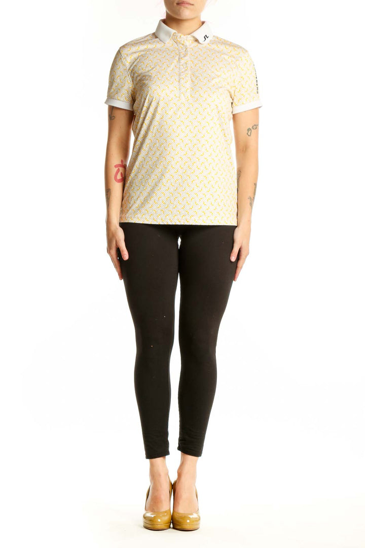 J. Lindeberg yellow geometric print polo shirt with white collar trim, front view on model