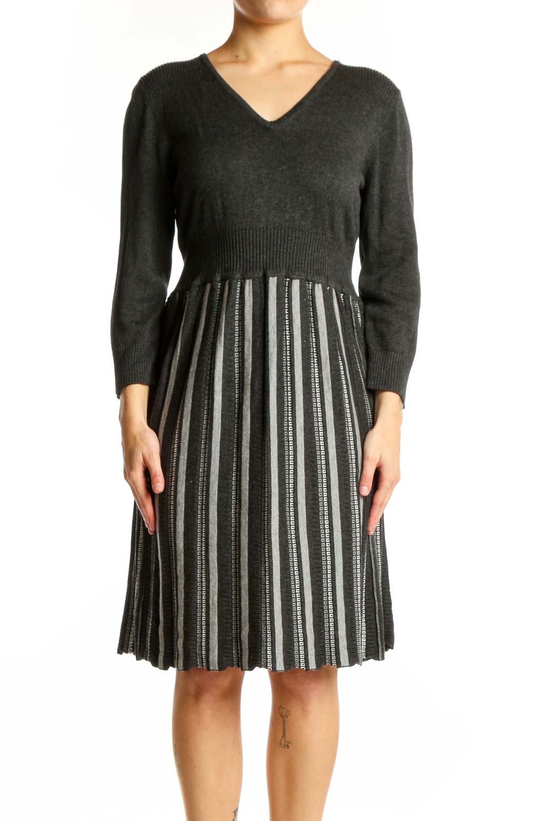 Front view of charcoal striped pleated knit dress with V-neckline and three-quarter sleeves