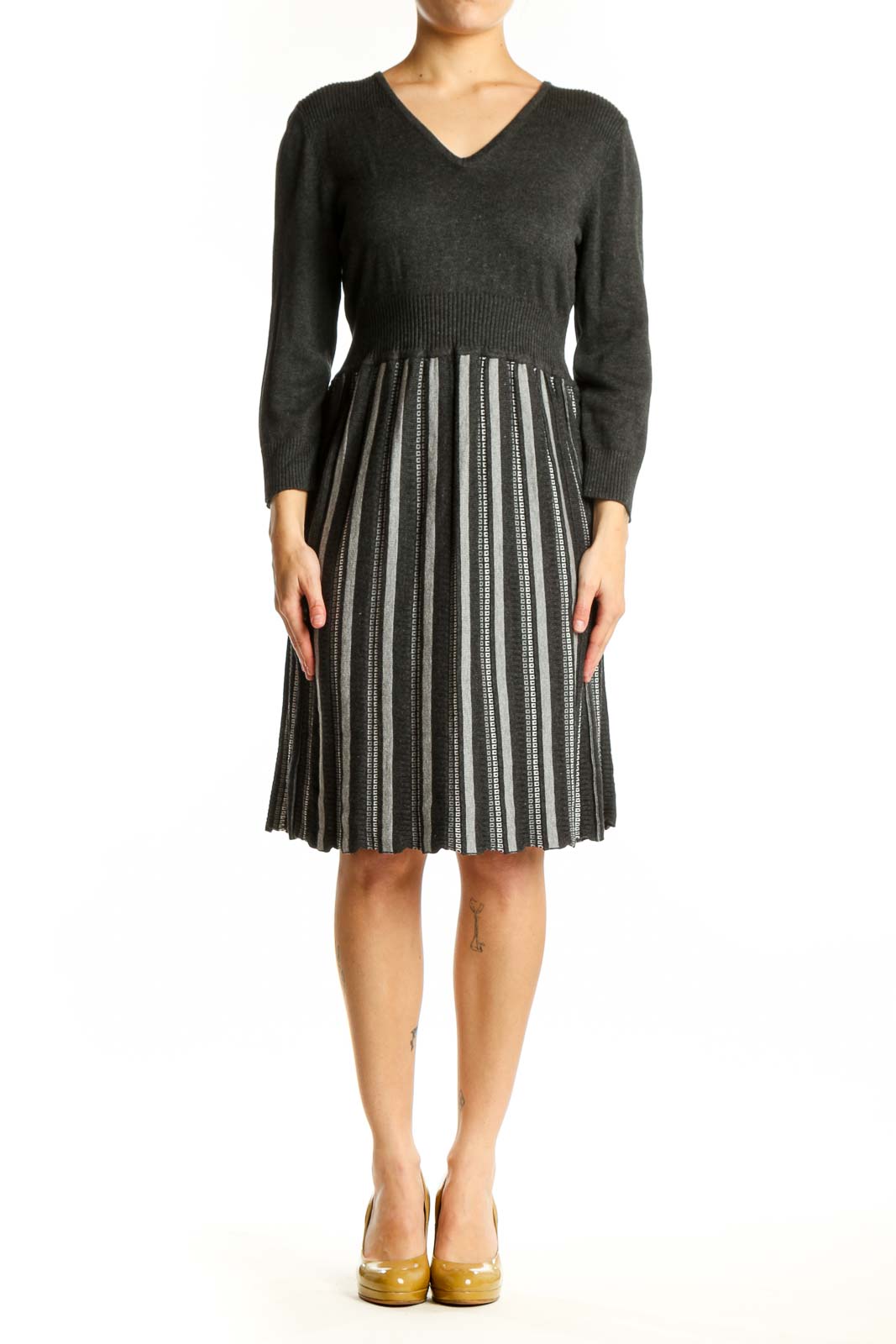 Front view of charcoal striped pleated knit dress with V-neckline and three-quarter sleeves