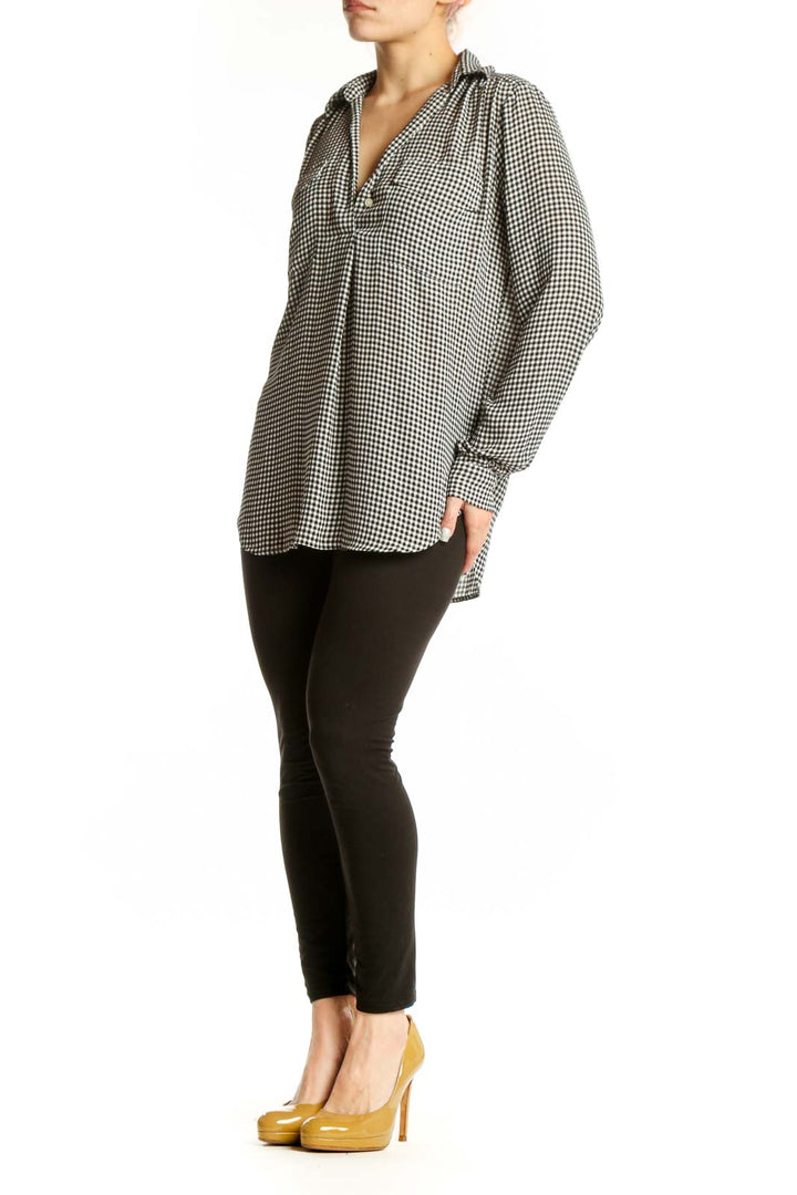 Black and white gingham button-up blouse with V-neckline and long sleeves, front view