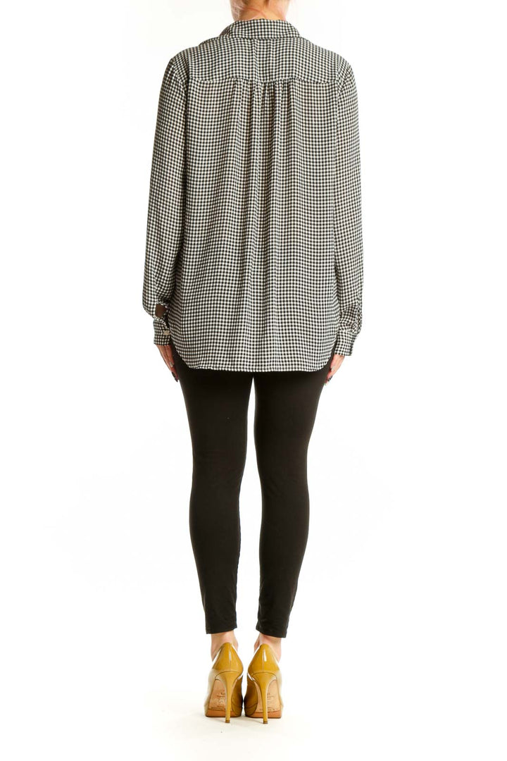 Black and white gingham button-up blouse with long sleeves, back view