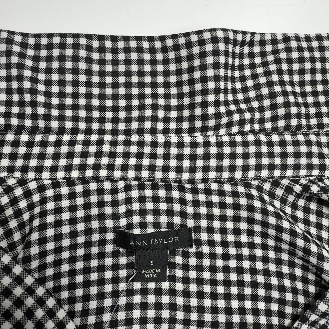 Black and white gingham button-up blouse with long sleeves, back view