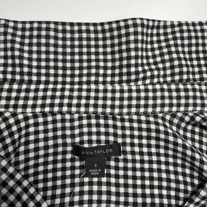 Black and white gingham button-up blouse with long sleeves, back view