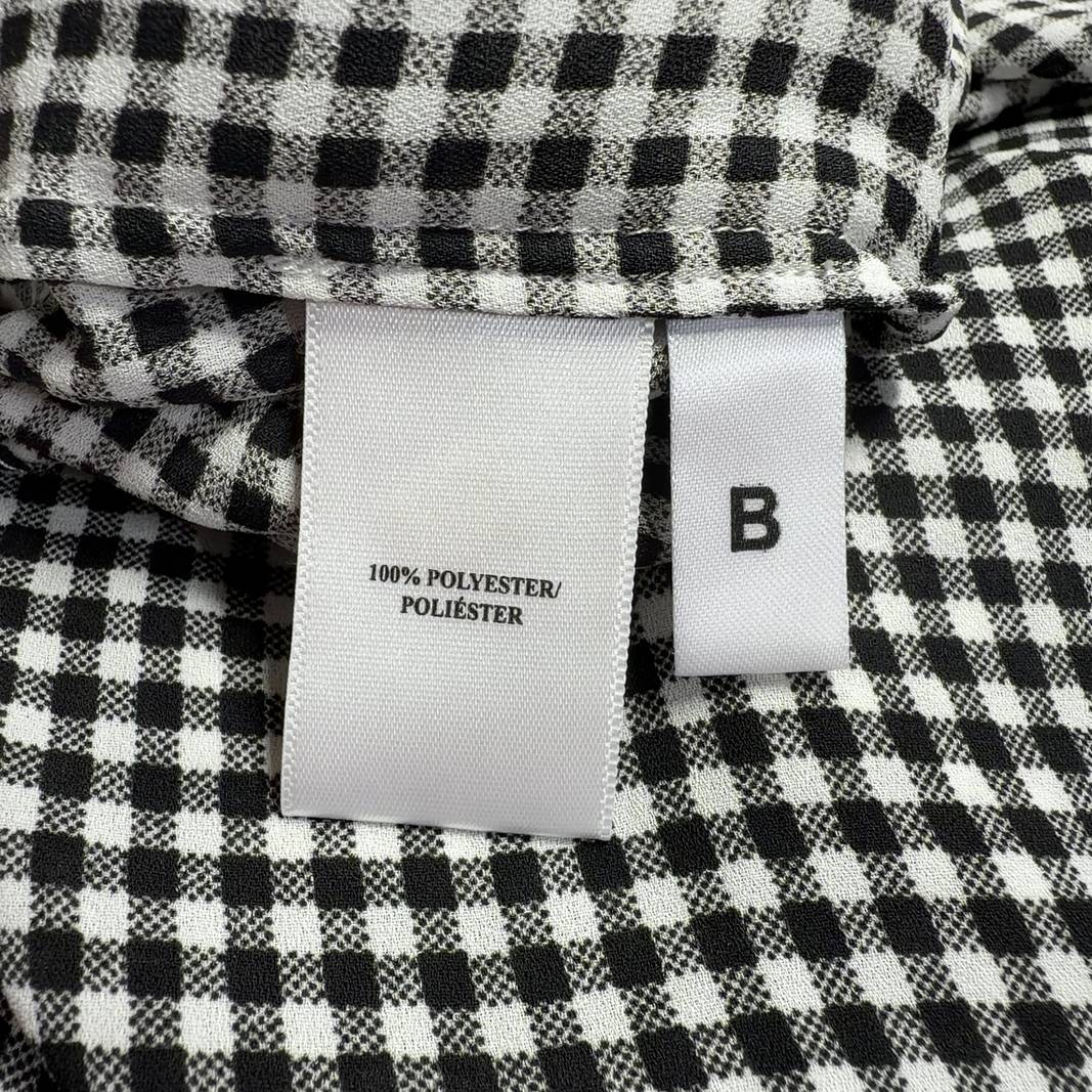 Black and white gingham button-up blouse with long sleeves, back view