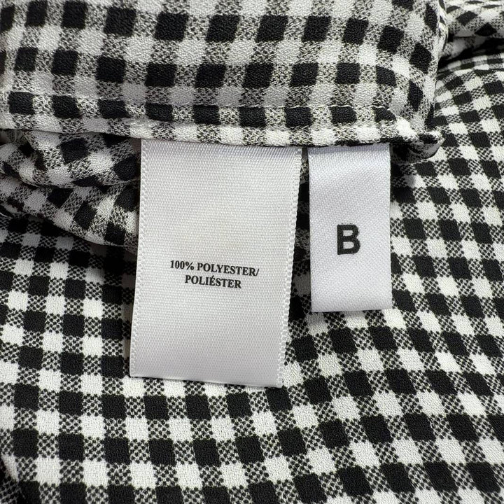 Black and white gingham button-up blouse with long sleeves, back view