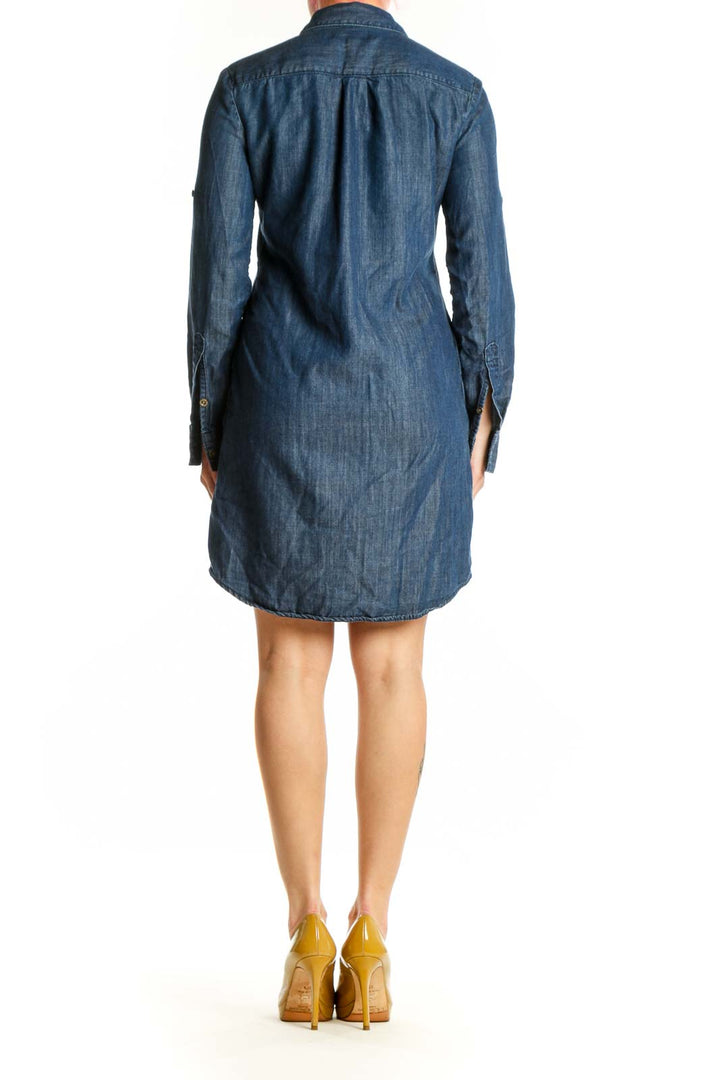 Blue denim button-up shirt dress with long sleeves and relaxed fit, back view