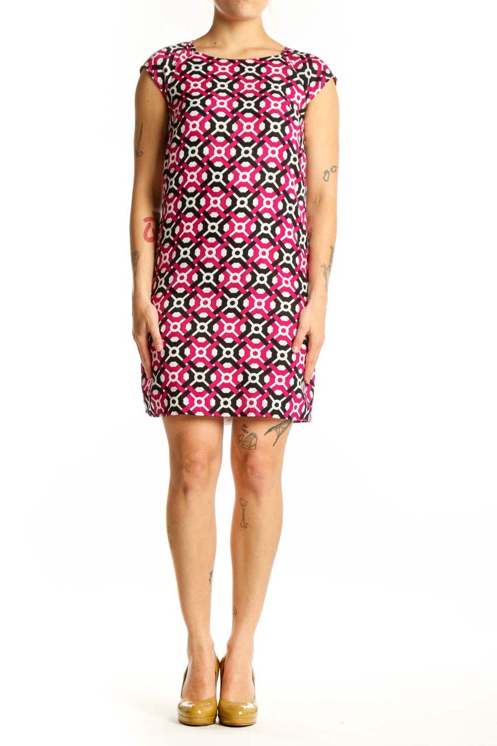 Front view of pink geometric print shift dress with black and white pattern, cap sleeves, and crew neckline