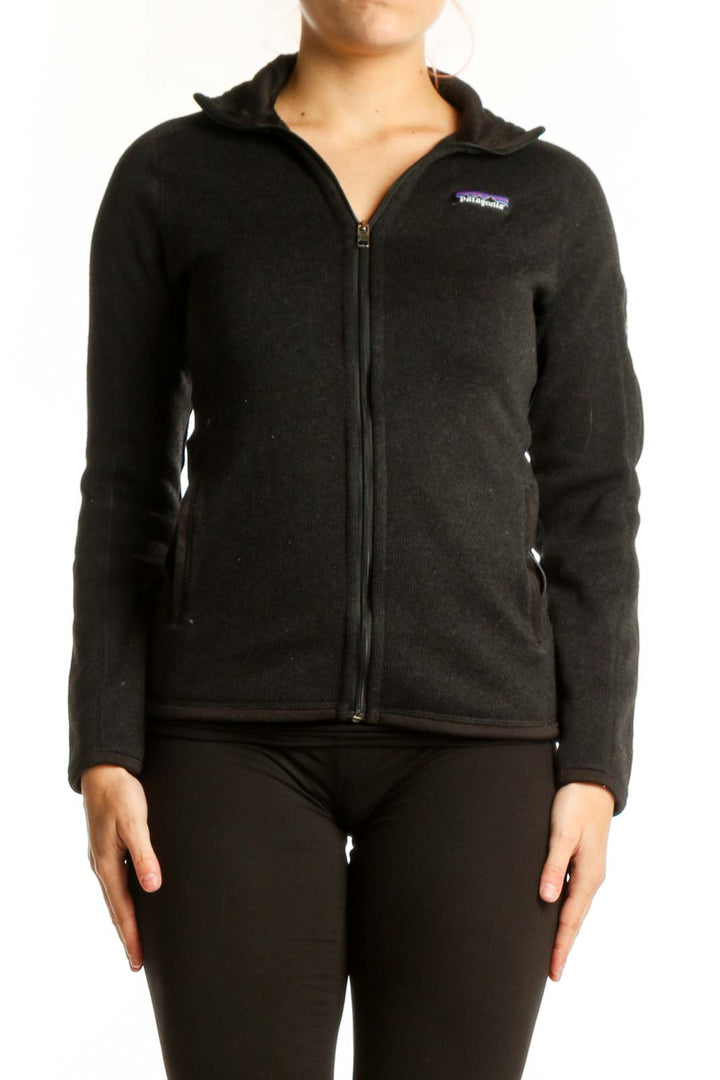 Patagonia black recycled polyester zip-up hoodie front view on model, XS size with full-zip closure and hooded neckline