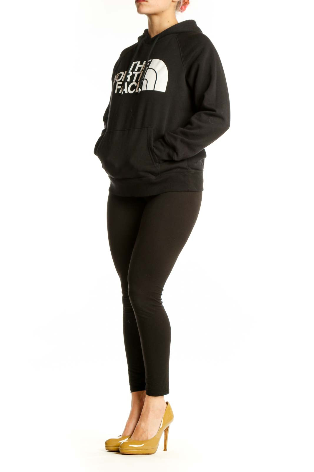 Black The North Face hoodie with white logo on front, worn by model showing kangaroo pocket and drawstring hood