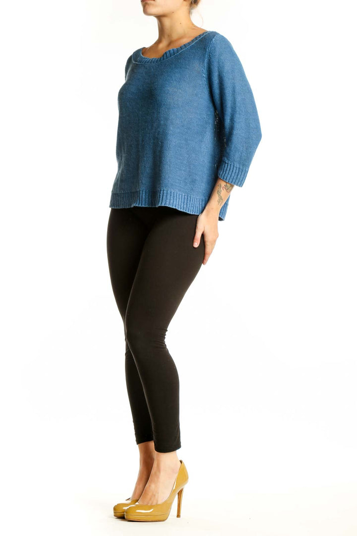 Blue linen knit sweater with crew neckline and three-quarter sleeves, front view on model