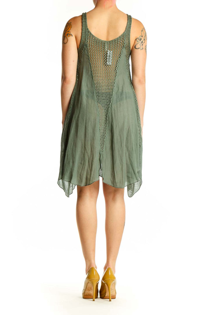 Back view of sage green mesh overlay asymmetrical tank dress showing flowing handkerchief hem