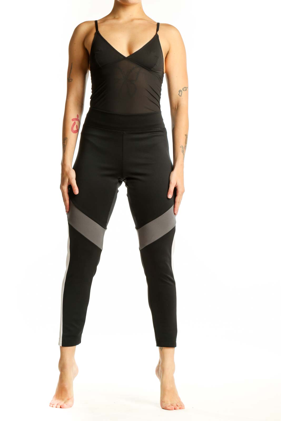 Adidas black colorblock leggings with gray and white paneling, front view showing high-waisted design and cropped length