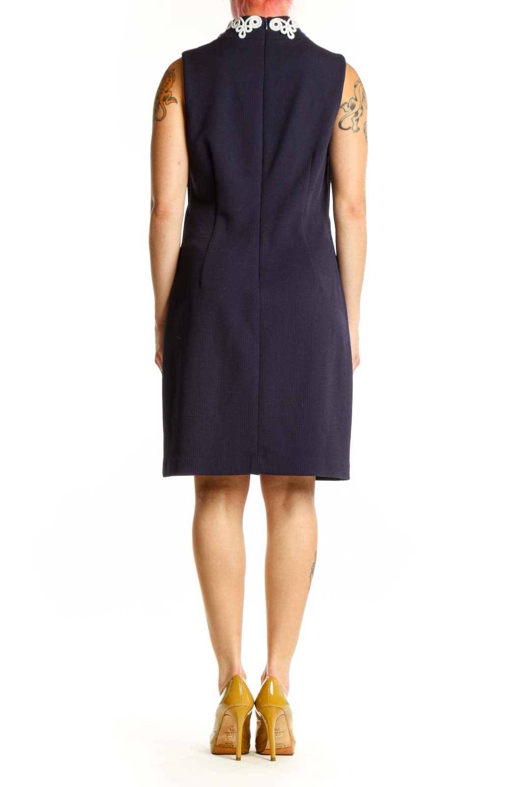 Back view of navy shift dress displaying white lace trim detail running down the center back, showing relaxed fit and knee-length hem