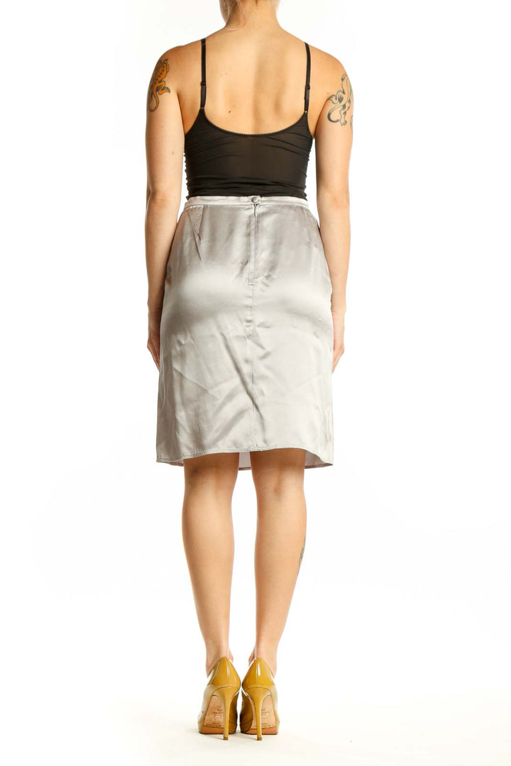 Cream silk pencil skirt back view, displaying elegant drape and classic straight cut design