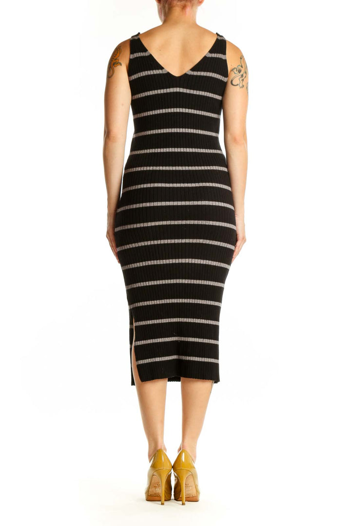 Black and cream striped midi bodycon dress with V-neckline, back view showing form-fitting silhouette