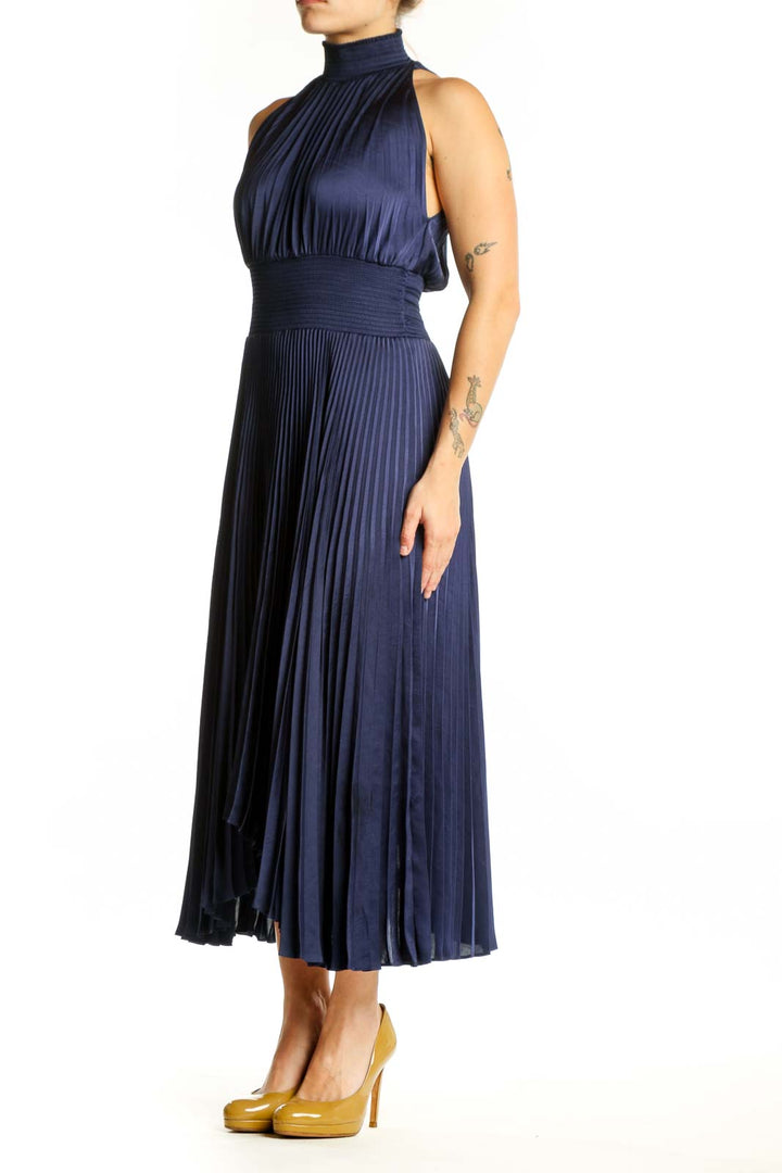 Navy pleated halter midi dress with cinched waist and asymmetrical hemline, front view