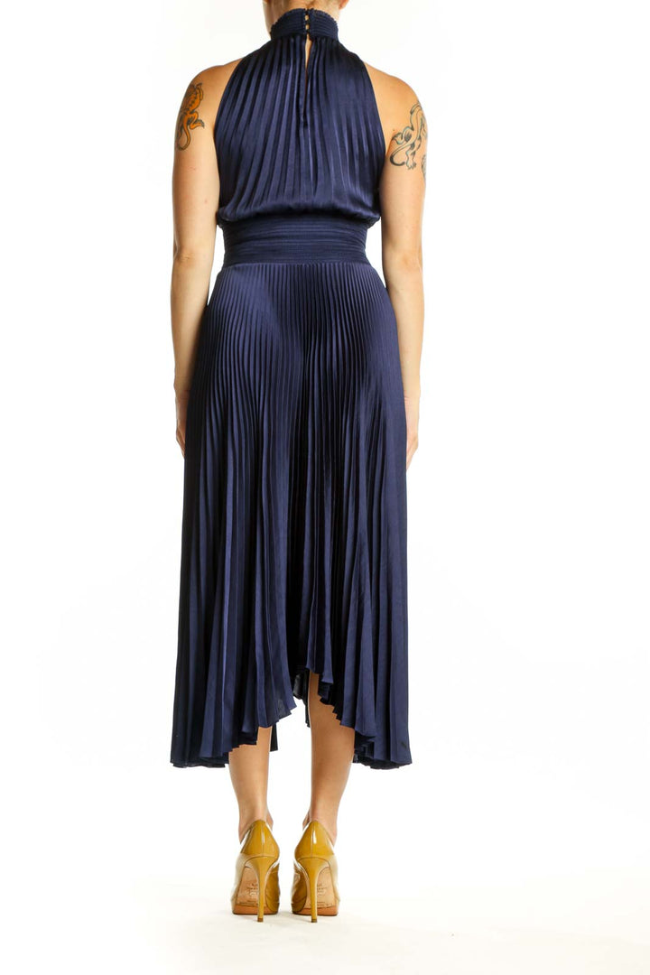 Navy pleated halter midi dress showcasing elegant back design and flowing pleated skirt