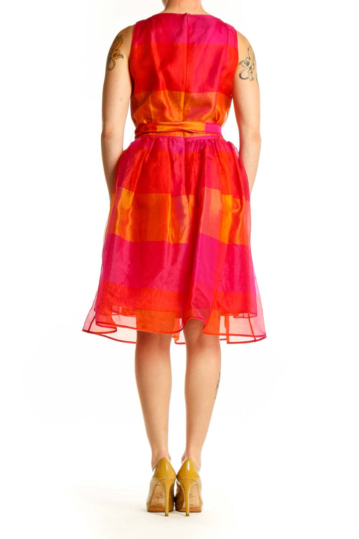 Back view of red orange patchwork midi dress showing colorblock design and A-line silhouette