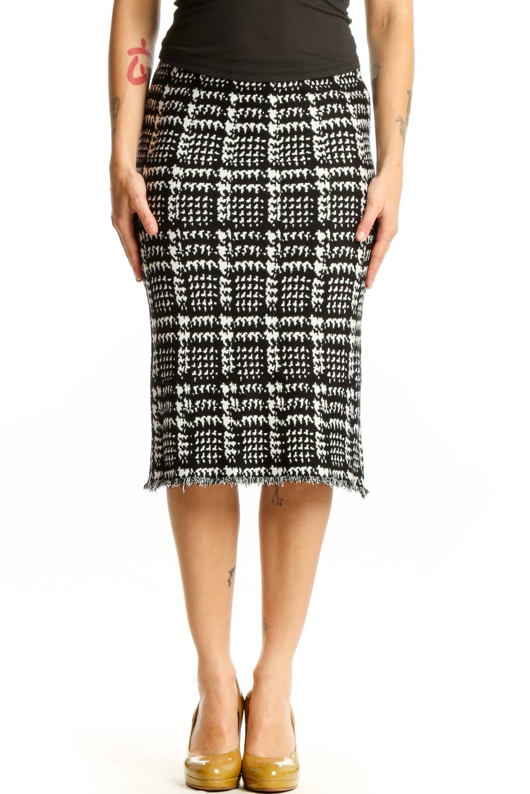Black and white houndstooth pencil skirt with frayed hem, front view on model
