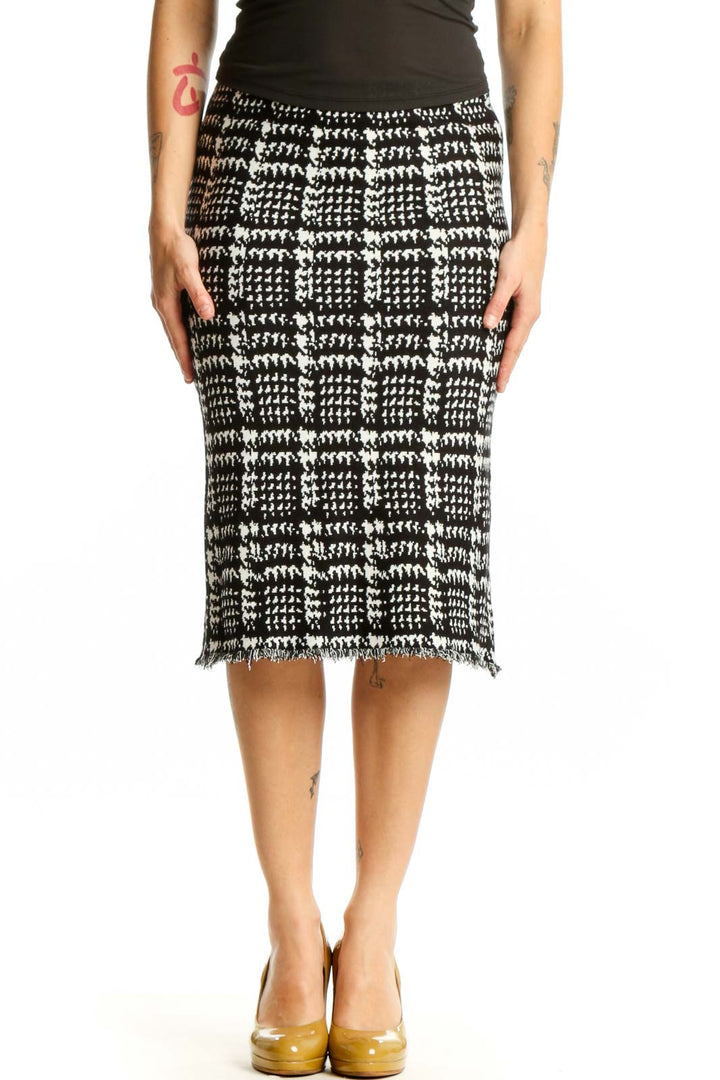 Black and white houndstooth pencil skirt with frayed hem, front view on model