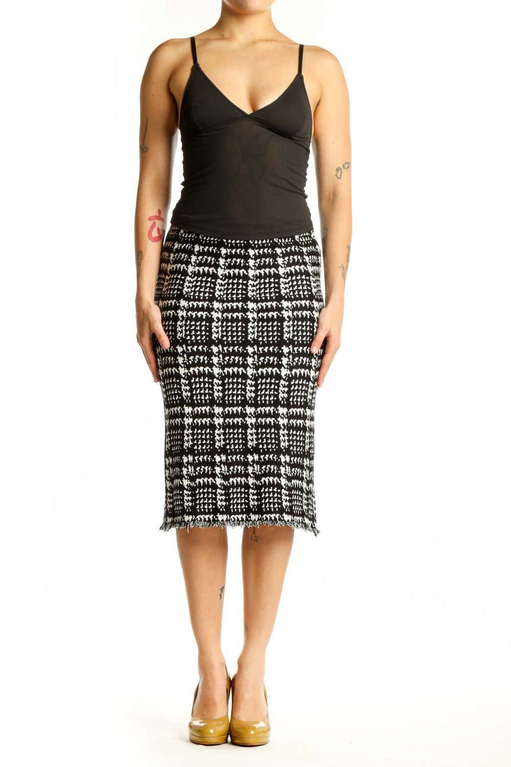 Black and white houndstooth pencil skirt with frayed hem, front view on model