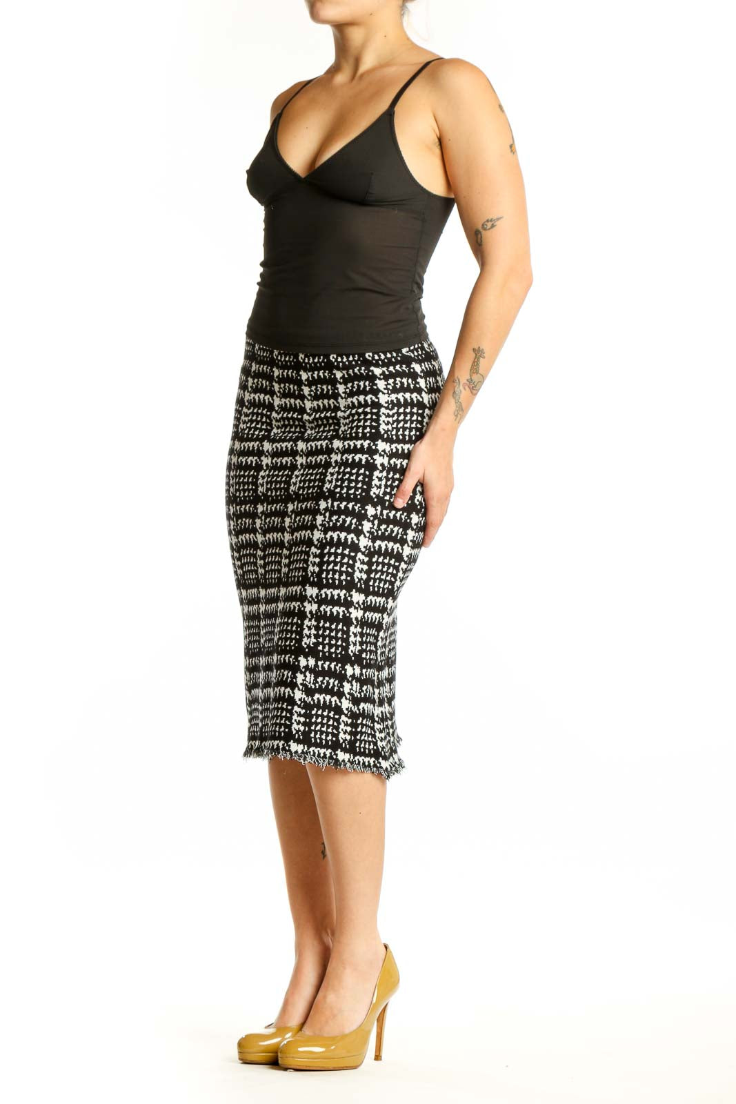 Black and white houndstooth pencil skirt with frayed hem, front view on model