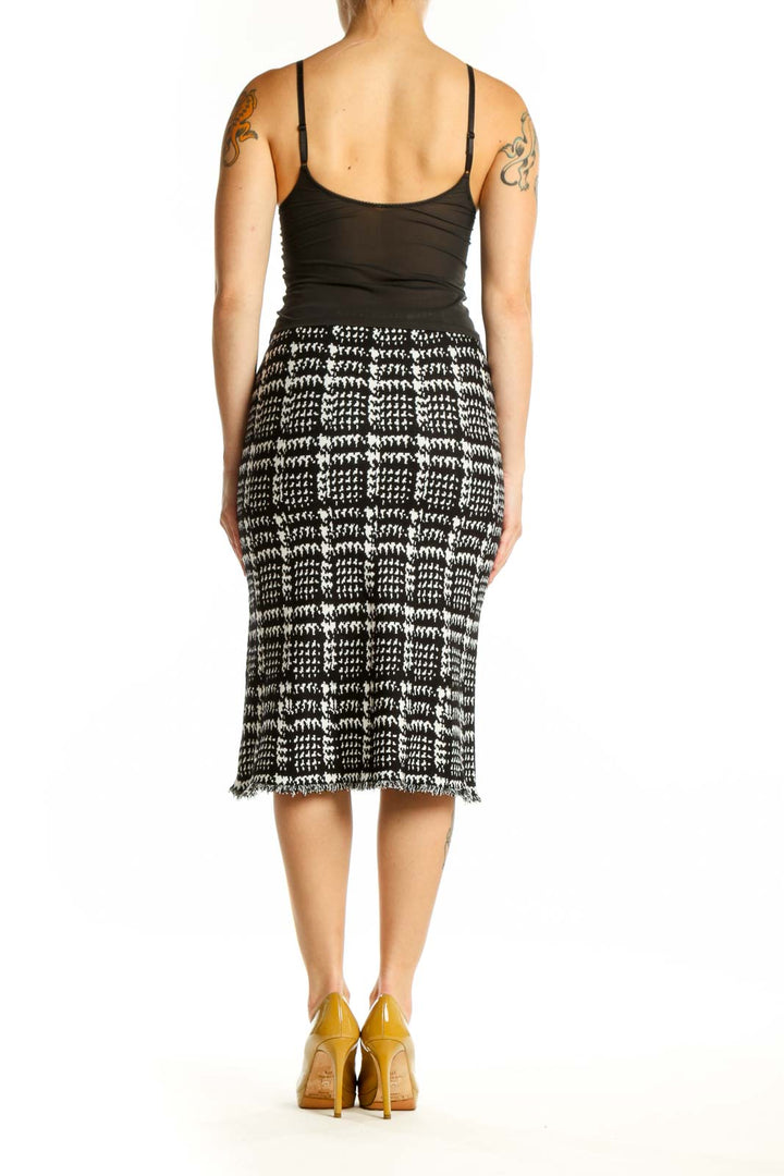 Black and white houndstooth pencil skirt with frayed hem, back view on model