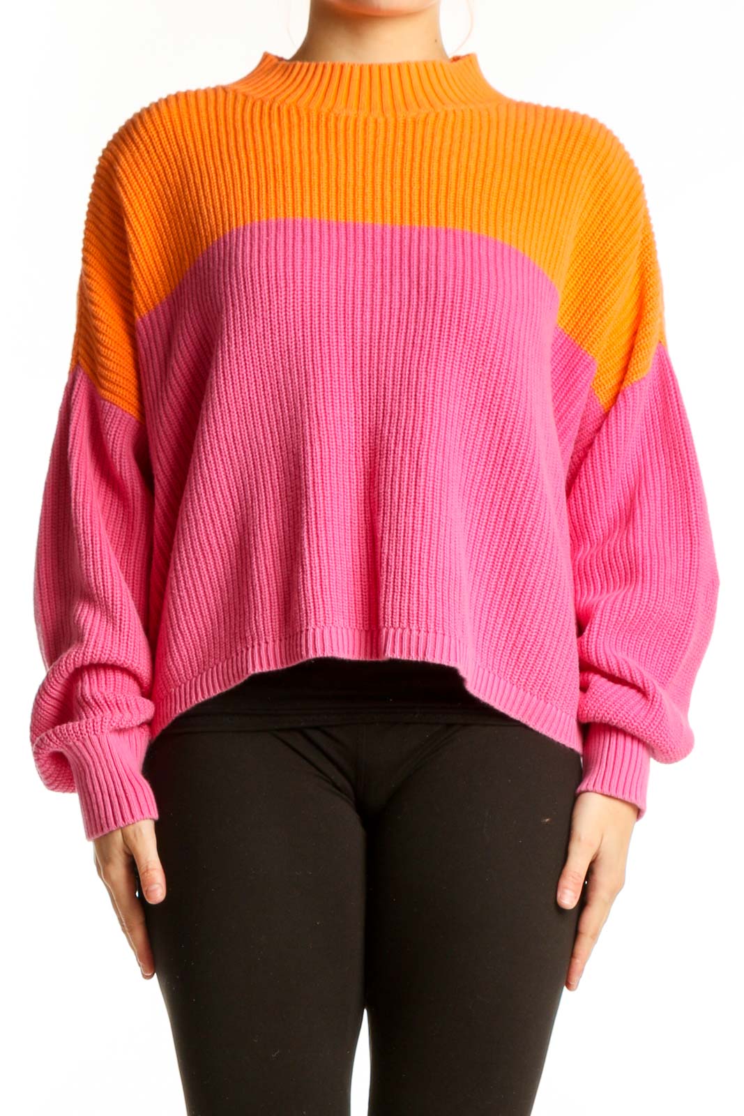 Orange and pink color block knit pullover with crew neckline and long sleeves, front view
