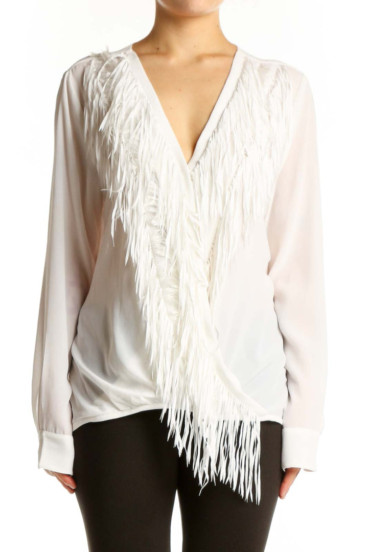 Cream wrap blouse with dramatic fringe detailing and V-neckline by Yoana Baraschi