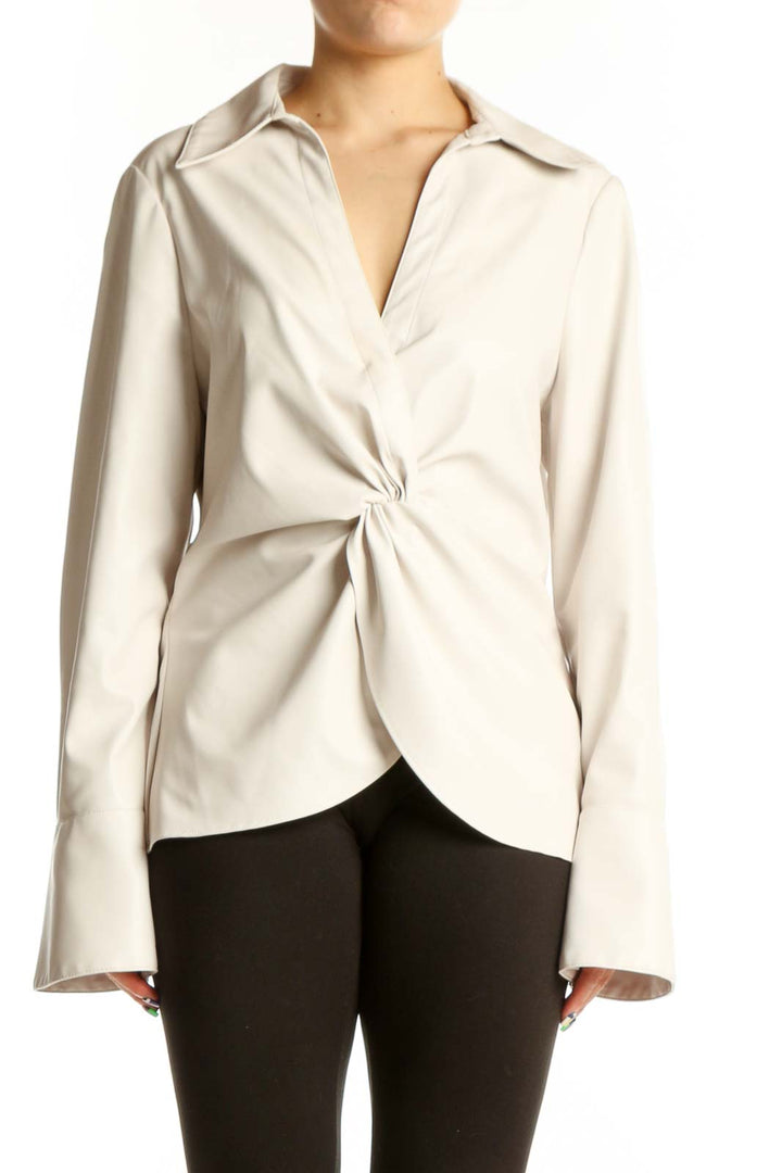 Cream faux-leather twist-front blouse with long sleeves and collared neckline, front view