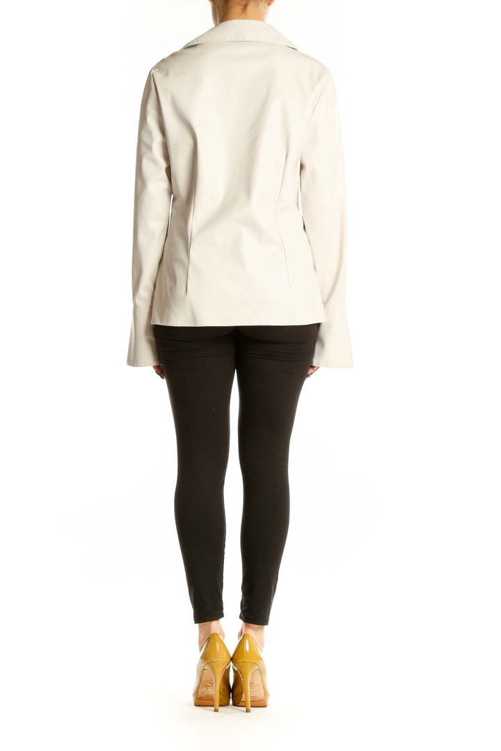 Cream faux-leather twist-front blouse with long sleeves, back view showing elegant draping