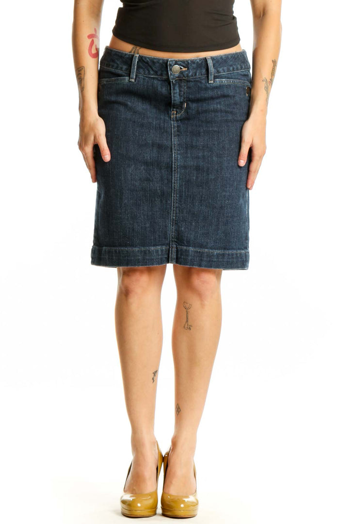 Dark blue denim knee-length skirt with rolled hem, front view on model wearing black top
