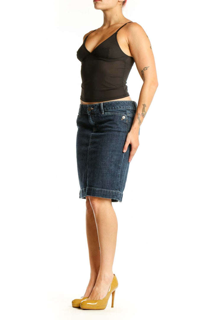 Dark blue denim knee-length skirt with rolled hem, front view on model wearing black top