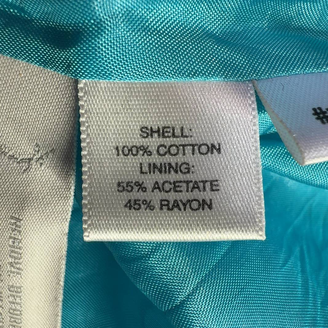 Tag view of turquoise petite blazer showing tailored fit and cropped length