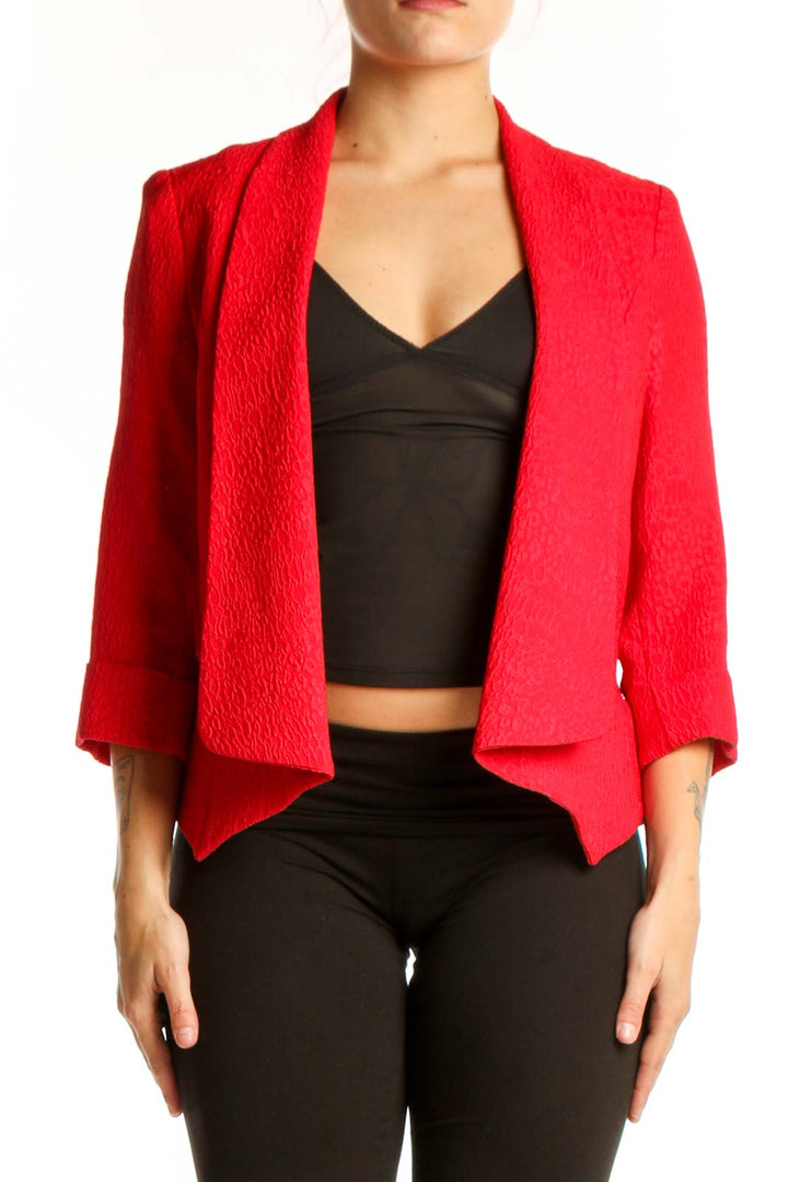 Red textured blazer by Alberto Makali with open-front design and three-quarter sleeves, worn with black crop top